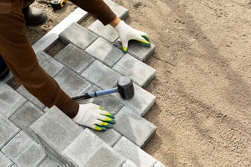 worker installing block paving worker installing block paving